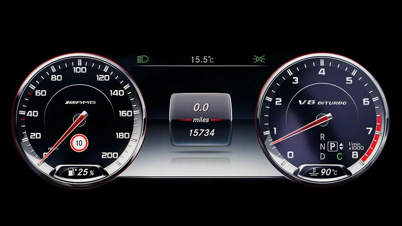 A compact sedan driving in daylight with the dashboard fuel economy display visible